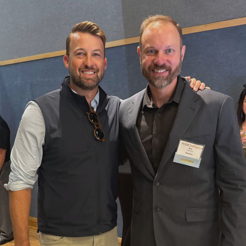 Eric Fleming, NewMile CTO and 2026 Ultimate Tech Leader honoree, with a colleague