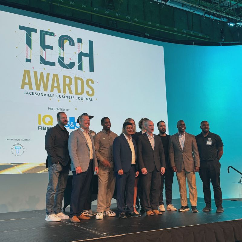 NewMile team on stage at the Jacksonville Business Journal Tech Awards